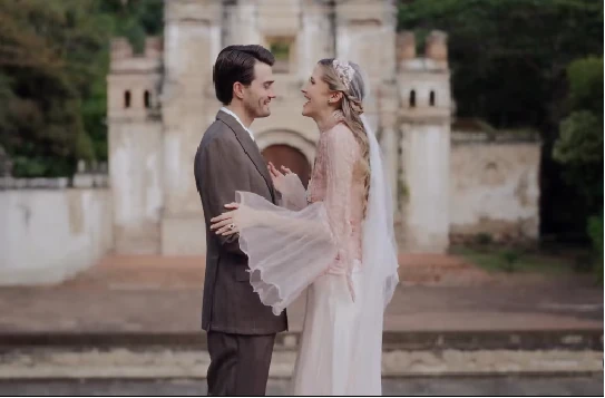 Alexa and Felipe smiling in front of colonial ruins at Villa Bokeh
