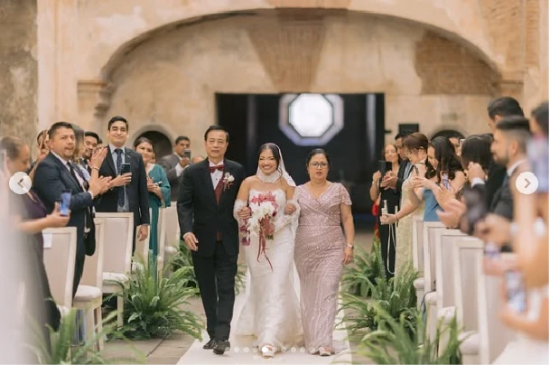 Bride walking down the aisle with her parents