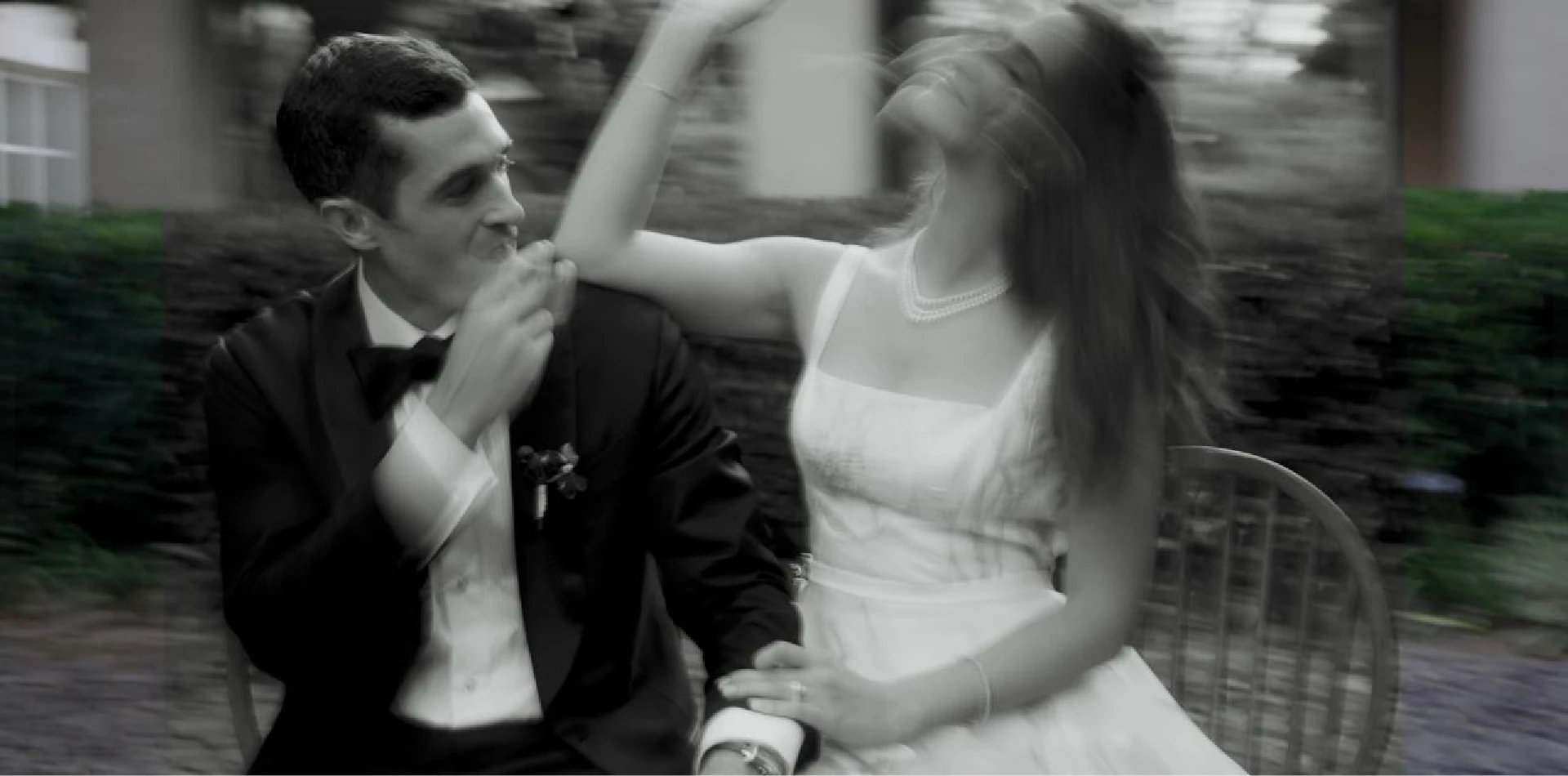 Bride and groom dancing playfully, black and white